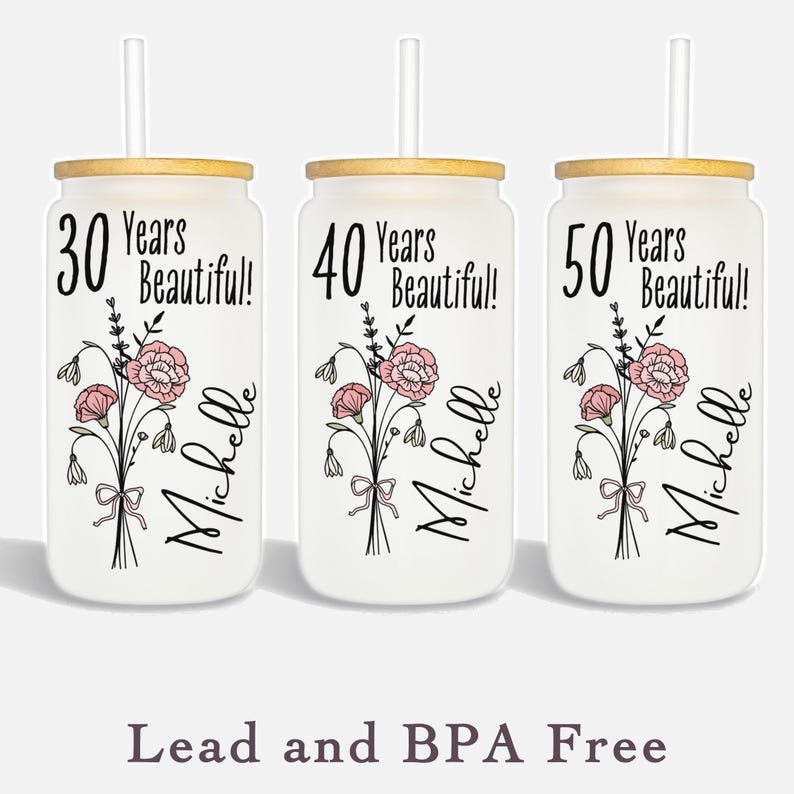colored Birthflower personalized 
Glass tumblers for birthday gift birth month flower shown on three different tumblers 30 years beautiful 40th birthday 50 years old birthday gift with years old and name script in black flower is in color