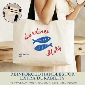 Sardines sailorcore Mediterranean Large zipper close canvas sardines tote bag for women with interior zipper pocket featuring bold blue and red sardine artwork and personalized name in script on cream coastal canvas. Sailorcore and sardinecore Mediterranean market bag style perfect as a coastal tote bag Italian summer beach bag and seaside gift with optional matching pencil pouch sold separately.