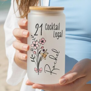 21st birthday glass with the number 21 and says cocktail legal colored birthflower personalized with name February birth flower shown Iris on frosted glass tumbler