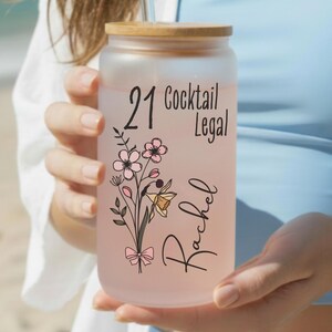 21st birthday glass with the number 21 and says cocktail legal colored birthflower personalized with name February birth flower shown Iris on frosted glass tumbler