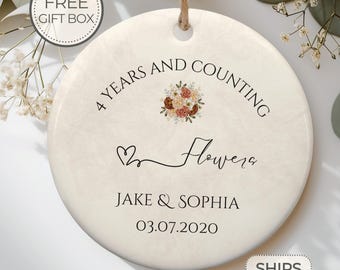 May include: Round ceramic ornament with a floral design and the text "4 Years and Counting Flowera Jake & Sophia 03.07.2020".