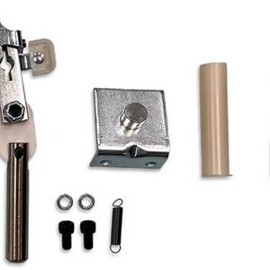 May include: A set of silver-toned metal parts for a window blind. The set includes a metal bracket, a metal rod with a silver-toned plastic piece, a metal spring, and a metal rod with a brown plastic piece.