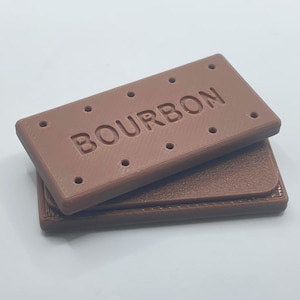 May include: A brown chocolate biscuit with the word "BOURBON" embossed on the top. The biscuit is stacked on top of another similar biscuit.
