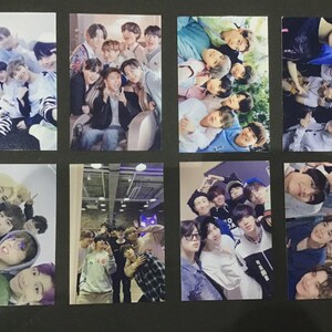 May include: A collection of eight photo cards featuring various group photos of a boy band. The cards showcase different poses and settings, with the members dressed in casual attire. The images have a variety of colors and lighting.