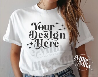 May include: White t-shirt mockup with the text "Your Design Here" in a retro font. The shirt is being worn by a person with long blonde hair. The text "Millie Mila" is visible in the lower right corner of the image.