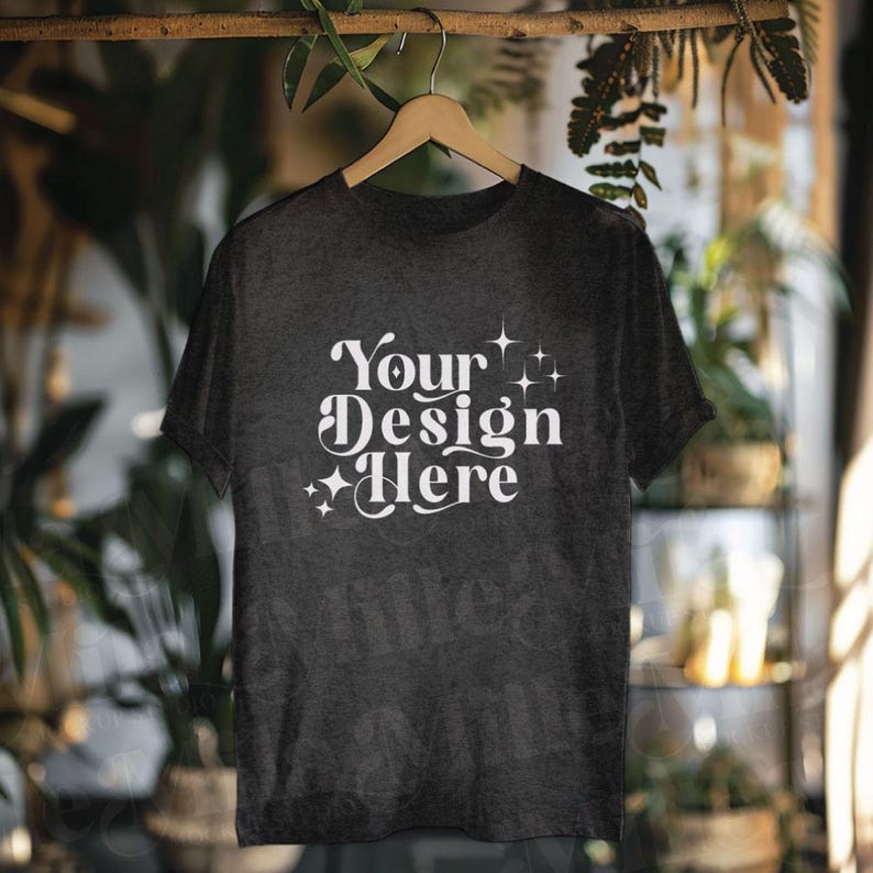 May include: A dark gray t-shirt with a white design that says "Your Design Here" with stars around the text.