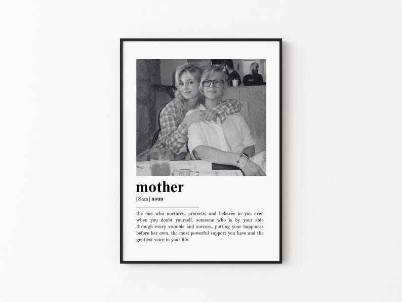 May include: Black and white framed print featuring a photograph of two people embracing. The word "mother" is printed below the image, along with a definition. The definition describes a mother's nurturing and supportive role.