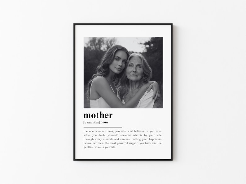 May include: Black and white framed print featuring a photograph of two women embracing. The word "mother" is printed below the image, along with a definition. The frame is black, and the background is white.