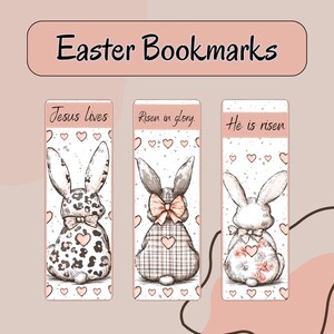 May include: Three Easter-themed bookmarks with bunny illustrations. Each bookmark features a different bunny design, with text that reads "Jesus lives", "Risen in glory", and "He is risen". The bookmarks have a pink and white colour scheme.
