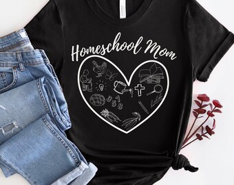 May include: Black t-shirt with white text that reads "Homeschool Mom" and a white heart filled with various homeschool-related icons, including a book, a cross, a pencil, a lightbulb, a watering can, a chicken, a butterfly, a loaf of bread, and numbers.
