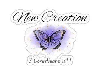 May include: A purple watercolour background with gold glitter and a black butterfly. The text "New Creation" is above the butterfly and the text "2 Corinthians 5:17" is below the butterfly.