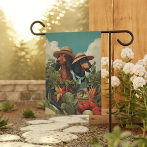 May include: A garden flag featuring two dachshunds wearing straw hats, surrounded by a bountiful harvest of vegetables. The artwork depicts a basket of carrots, tomatoes, and other produce, set against a backdrop of a blue sky with clouds.
