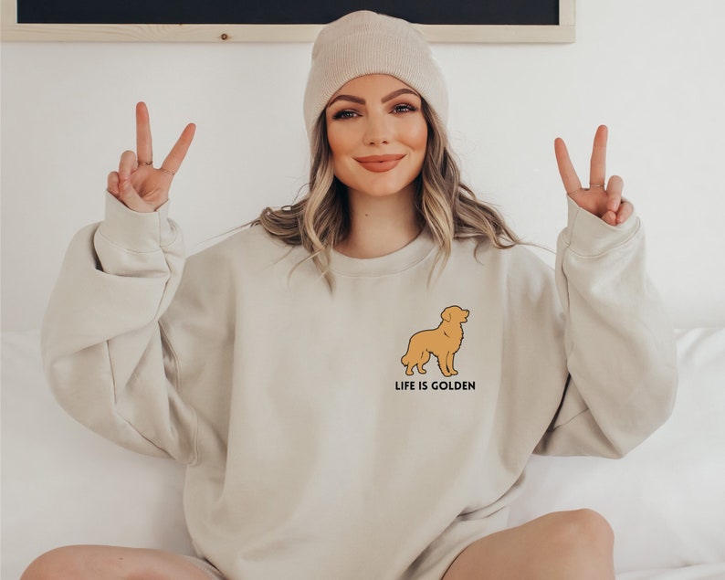 May include: A beige sweatshirt with a golden retriever silhouette and the text "Life is Golden".