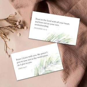 May include: Two white cards with inspirational quotes and palm leaf designs. One card reads "Trust in the Lord with all your heart..." from Proverbs 3:5-6. The other card reads "Peace I leave with you..." from John 14:27.