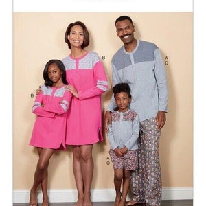 May include: A family matching pajama set pattern with a gray and white color scheme. The pattern includes a long-sleeved shirt and pants for adults and a long-sleeved shirt and shorts for children. The pattern is labeled "Butterick B6531".