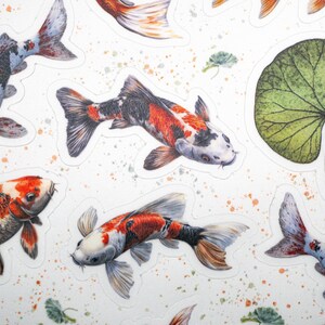 May include: A set of colorful koi fish stickers with black, white, red, and orange markings. The stickers are on a white background with a green leaf and water droplets.