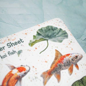 May include: A sticker sheet with the text "Sticker Sheet koi fish" and illustrations of koi fish and a green lotus leaf.