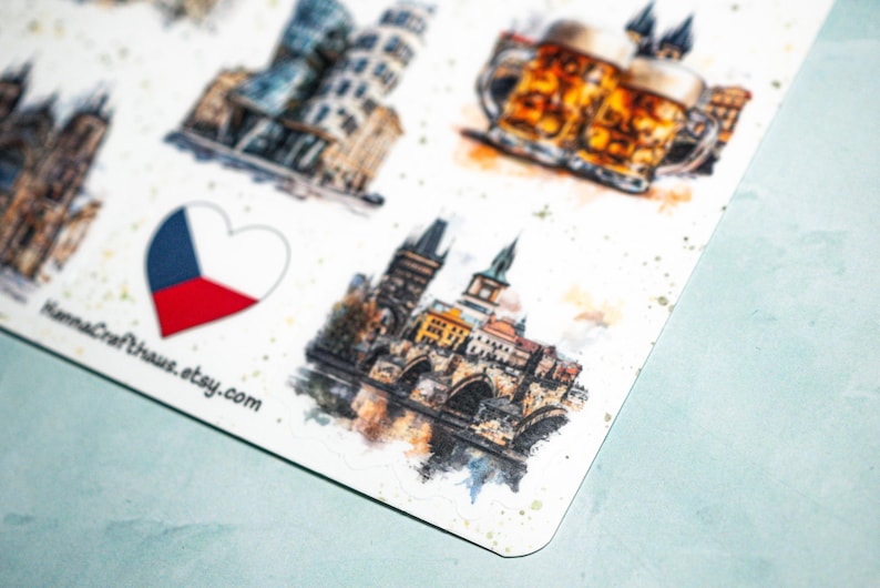 May include: A sheet of stickers featuring watercolor illustrations of Czech Republic landmarks, including the Charles Bridge, a beer stein, and the Leaning Tower of Pisa. A heart-shaped Czech flag is also included. The Etsy shop name "HannaCrafthaus.etsy.com" is visible.