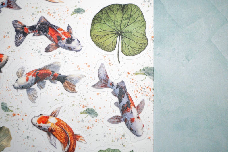 May include: A sheet of stickers featuring colorful koi fish and green leaves. The stickers are printed on white paper and have a glossy finish.