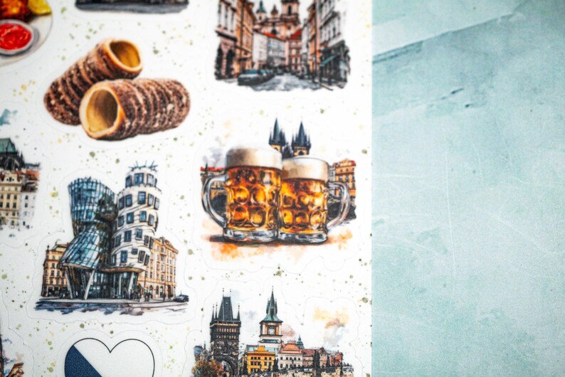 May include: Watercolor illustrations of Czech Republic landmarks and food items. The images include Trdeln&iacute;k pastries, beer steins, and architectural scenes of Prague. The stickers have a white background with gold speckles and a light blue background.