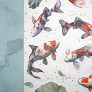 May include: A sheet of colorful koi fish stickers. The stickers feature a variety of koi fish in different colors and patterns, including orange, white, black, and red. The stickers are perfect for adding a touch of whimsy to any project.