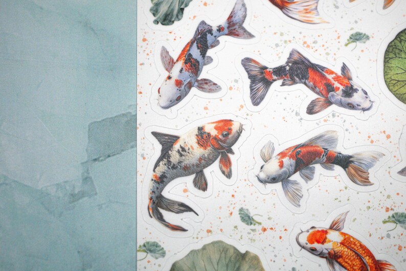 May include: A sheet of colorful koi fish stickers. The stickers feature a variety of koi fish in different colors and patterns, including orange, white, black, and red. The stickers are perfect for adding a touch of whimsy to any project.
