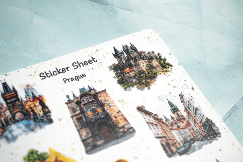 May include: A sticker sheet featuring watercolor illustrations of Prague landmarks. The sheet includes images of the Prague Castle, the Astronomical Clock, and other architectural details. The text "Sticker Sheet Prague" is printed at the top.