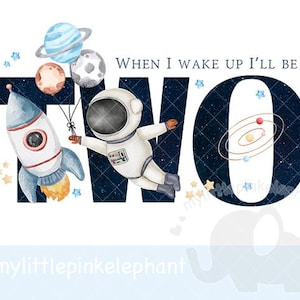 Puede incluir: Ilustración caprichosa con un cohete, un astronauta y planetas. La palabra "TWO" es prominente, con el texto "WHEN I WAKE UP I'LL BE" arriba. El diseño incluye estrellas y un sistema solar, perfecto para una temática de cumpleaños.