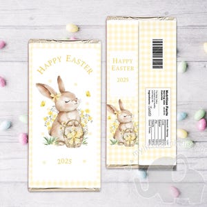 May include: Printable chocolate bar wrapper featuring a watercolor illustration of a brown bunny holding a basket of yellow Easter eggs. The wrapper has a yellow and white checkered background and the text "Happy Easter 2025".