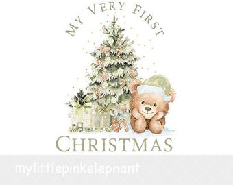 May include: A watercolor illustration featuring a brown teddy bear wearing a light green Santa hat next to a decorated Christmas tree and wrapped gifts. The text MY VERY FIRST CHRISTMAS is arched above and below the festive holiday scene.