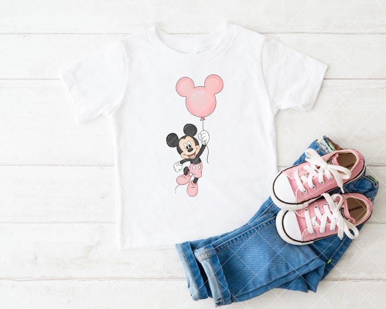 May include: White t-shirt with a Mickey Mouse cartoon holding a pink balloon. The image includes blue denim jeans and pink canvas trainers. A cheerful design for children.