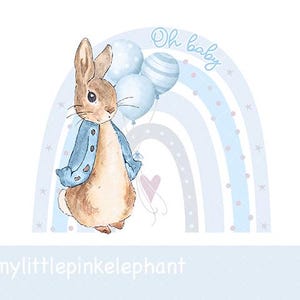 May include: Watercolor illustration of a bunny wearing a blue jacket, holding blue balloons, and standing in front of a blue rainbow. The words "Oh baby" are written above the rainbow. A pink heart is also present.