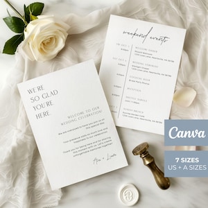May include: Two white wedding stationery cards with black text. One card reads WE'RE SO GLAD YOU'RE HERE and the other lists weekend events. A white rose, a brass wax seal stamp, and a white wax seal are placed alongside the printed paper cards.