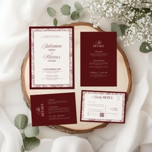 May include: A collection of burgundy wedding stationery, including an invitation, details card, RSVP card, and a details card. The invitation features the names "Julianna Smith and Marcus O'Hare" and the date "18 September 20XX". Floral accents frame the text.