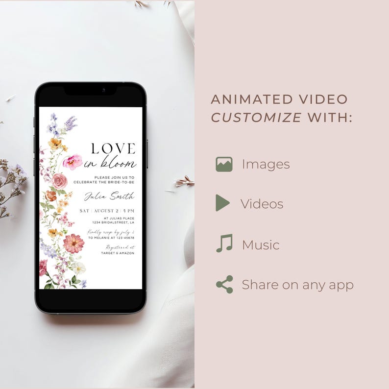 May include: A black smartphone displays a floral wedding invitation with the text "Love in Bloom." The invitation includes details like the bride's name, date, time, and location. Additional text on the right side promotes animated video customization with images, videos, music, and sharing.