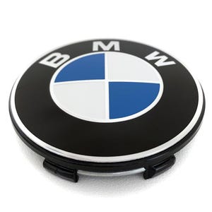 May include: A black and silver BMW wheel center cap with the BMW logo in the center. The logo features a blue and white quadrant design with the letters "BMW" in white.