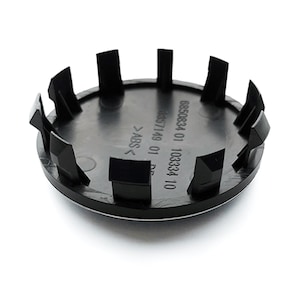 May include: Black plastic wheel center cap with the text "6850834 01 103334 10 0857149 01 DE >ABS<" printed on the back.