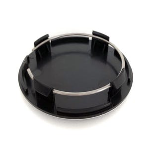 May include: Black plastic wheel center cap with a silver metal ring around the edge.