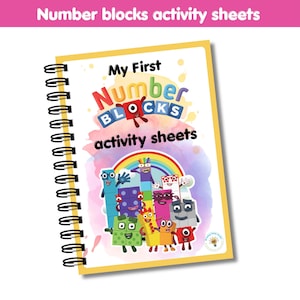 May include: A spiral-bound activity book with a yellow border. The cover features the text "My First Number Blocks activity sheets" with colourful cartoon characters and a rainbow. The top of the book has the text "Number blocks activity sheets" in pink.