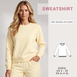 May include: A pale yellow long-sleeve sweatshirt with a crew neckline and ribbed cuffs. The image includes text reading SWEATSHIRT, PDF SEWING PATTERN, and SIZES: US 2 - 30, XS to 4 XL, alongside a technical line drawing of the garment.