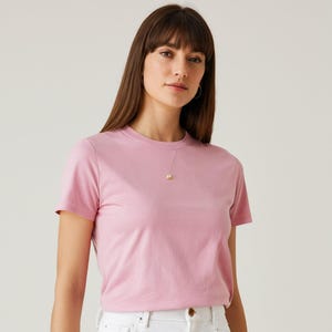 May include: A pink short-sleeved t-shirt with a crew neck.