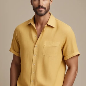 May include: A yellow short-sleeved button-down shirt with a chest pocket.