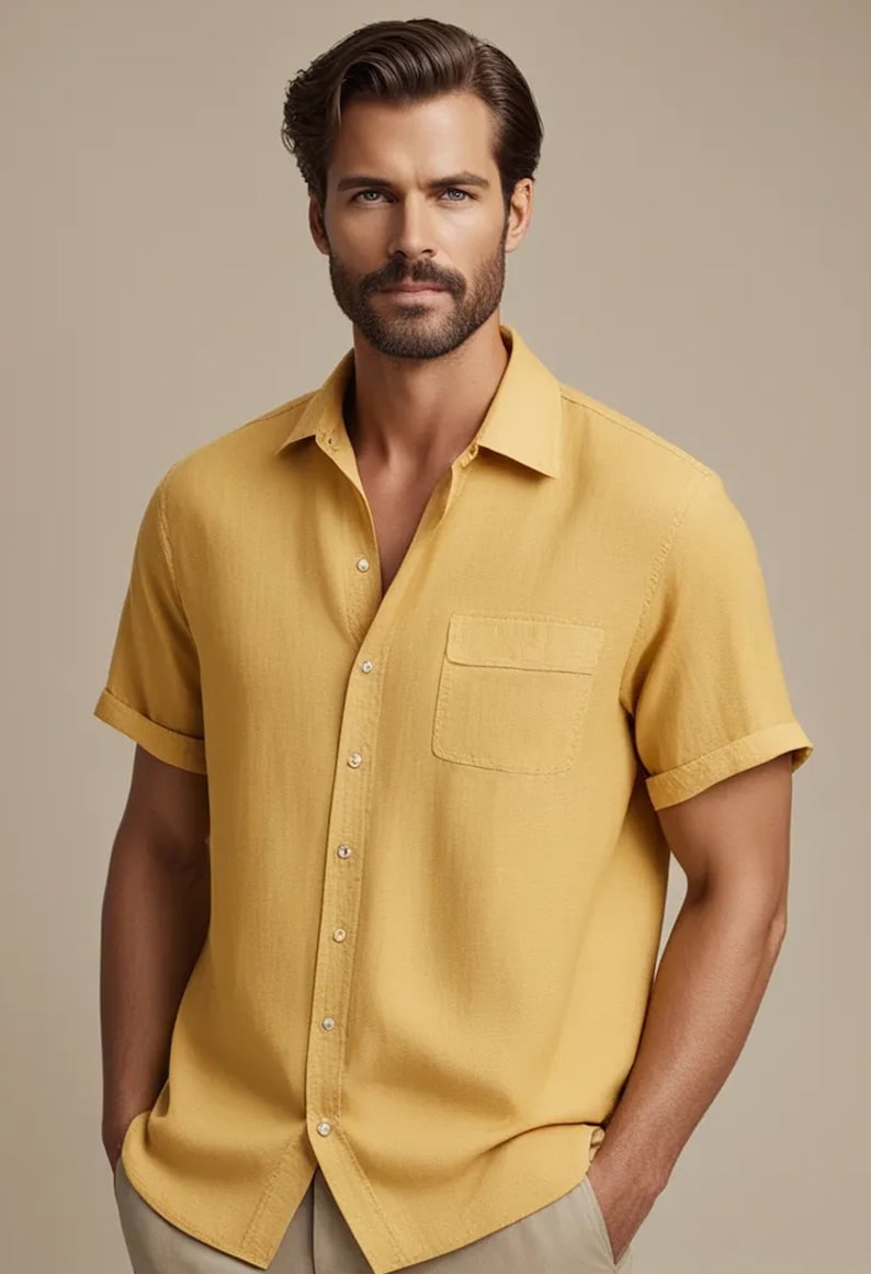 May include: A yellow short-sleeved button-down shirt with a chest pocket.