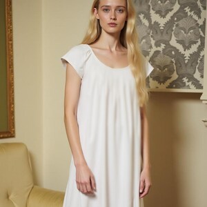 May include: A white cotton nightgown with a scoop neck and short sleeves.