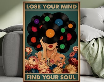 May include: A framed art print featuring a woman with vinyl records in place of hair, surrounded by flowers. The text "LOSE YOUR MIND" and "FIND YOUR SOUL" is displayed at the top and bottom. The artwork has a vintage, retro aesthetic with a teal background.