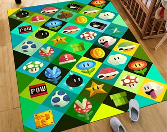May include: A green and blue checkered rug with a variety of video game characters and objects. The rug features a POW block, a star, a mushroom, a coin, and a turtle shell.