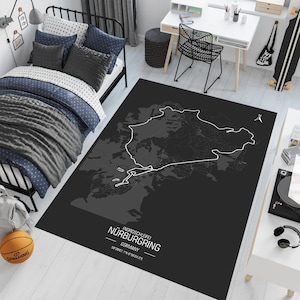 May include: Black and white map of the Nordschleife Nurburgring race track on a black rug. The text "(Nordschleife) Nurburgring, Germany, 20.832 km / 12.944 mi" is printed on the rug.