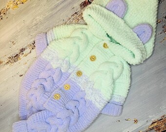 Handmade knitted overalls for a newborn baby.