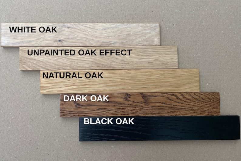 May include: Five wooden planks showcasing different oak finishes: White Oak, Unpainted Oak Effect, Natural Oak, Dark Oak, and Black Oak. Each plank has the finish name printed in white.