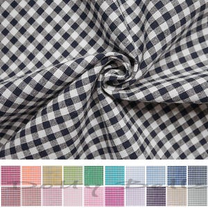 May include: A fabric featuring a classic navy blue and white gingham check pattern with a visible woven texture. The material is gathered in the center to show folds and depth. Below the main fabric, a grid displays twenty different color variations.